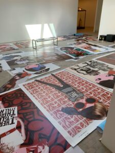 large prints of PhoebeNewYork spread on the floor before installation